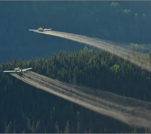 Two aircraft applying pesticides in forestry using Micronair atomisers